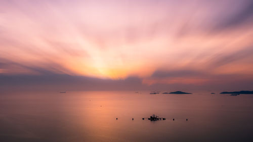 Scenic view of sea against romantic sky at sunset