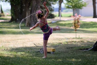 Full length of girl playing on grass