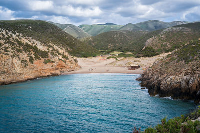 Scenic view of sea and mountains against sky