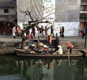 People in boat against building