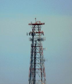 Low angle view of communications tower against sky