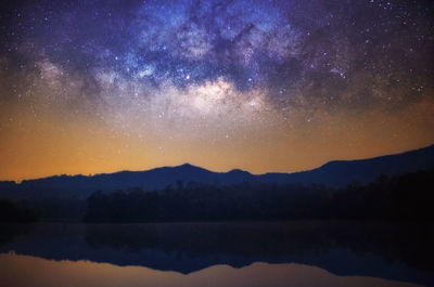 Scenic view of lake against sky at night