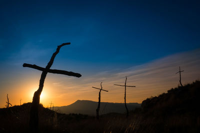 Low angle view of silhouette pole against sky during sunset