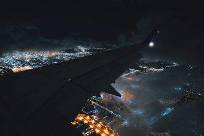 Aerial view of illuminated city against sky at night