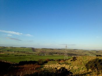 Scenic view of grassy field against cloudy sky