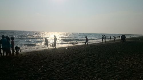 People on beach at sunset