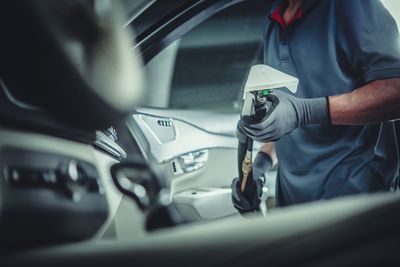 Midsection of man driving car