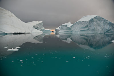 Scenic view of frozen sea against cloudy sky