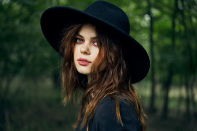 Portrait of young woman wearing hat