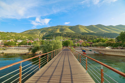 High angle view of people walking on footbridge against mountain