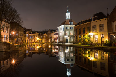 Reflection of illuminated buildings in canal at night