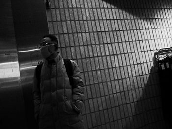 Man standing against window