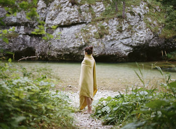 Rear view of woman standing against plants