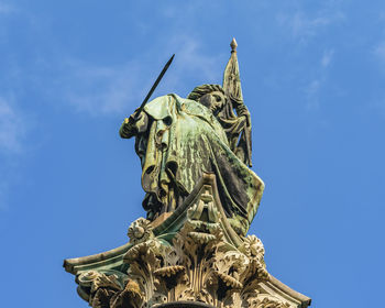 Low angle view of statue against blue sky