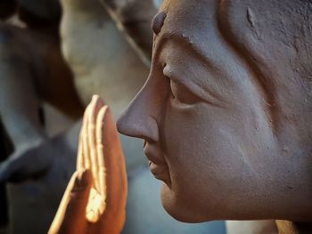 Close-up of statue of man holding sculpture