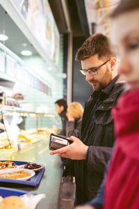 Man and woman standing by food stall