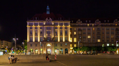 Group of people in front of building at night