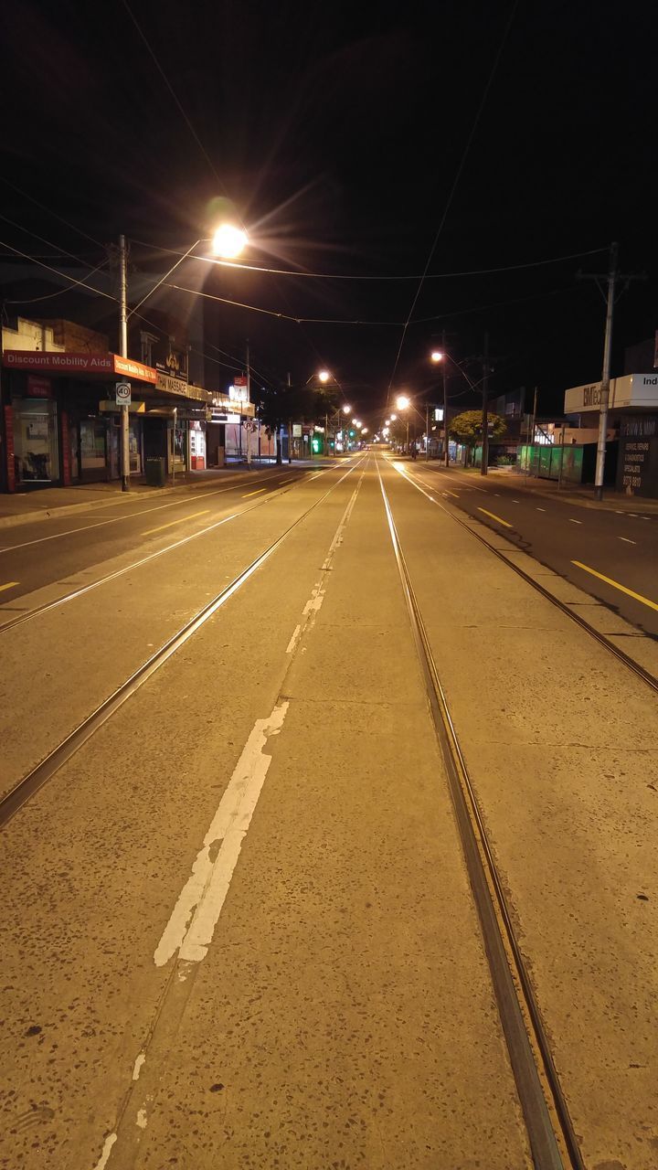 ILLUMINATED ROAD AGAINST SKY AT NIGHT