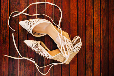 Close-up of shoes on wooden table