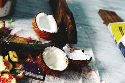 Close-up of halved coconut on table