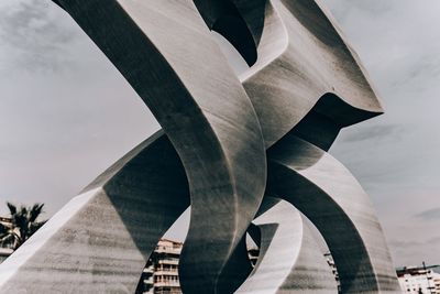 Digital composite image of bridge against cloudy sky