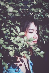 Close-up portrait of young woman looking away