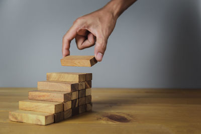 Close-up of hand holding toy stack on table