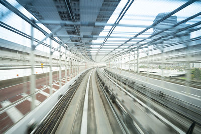 Blurred motion of railroad tracks seen through glass