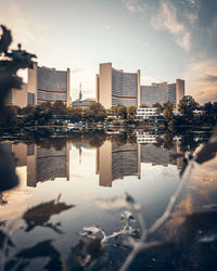 Reflection of buildings on water against sky