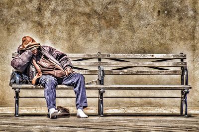 Man sitting on floor in city