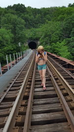 Full length of woman standing on footbridge