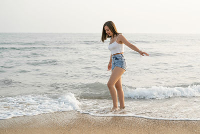Young woman standing at beach