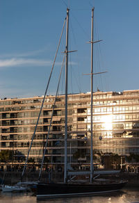Sailboat moored in sea against building