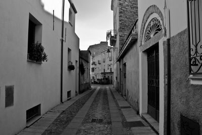 Empty alley amidst buildings in city