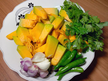 High angle view of chopped fruits in plate on table