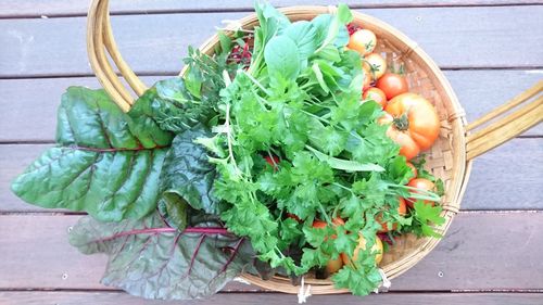 Directly above shot of vegetables in wicker basket on table