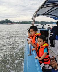 People sitting in boat against sky