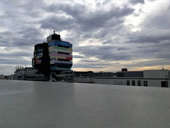 View of cityscape against cloudy sky