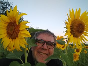 Portrait of smiling young woman with yellow sunflower