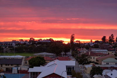 High angle view of townscape against orange sky