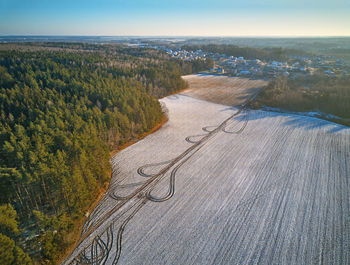 High angle view of road amidst trees against sky