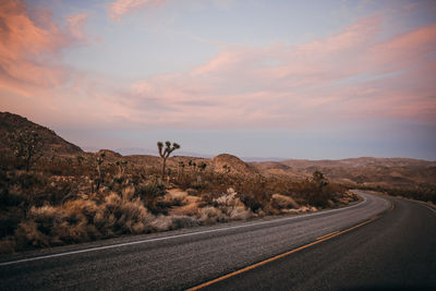 Windy road around mojave desert of joshua tree national park at sunset