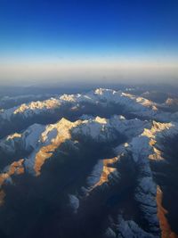 Aerial view of snowcapped mountain against sky