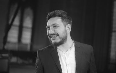 Smiling bearded man standing indoors