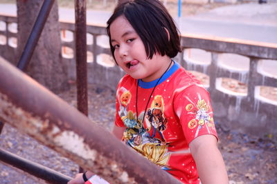 Portrait of girl sitting outdoors