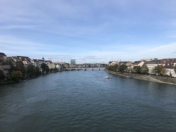 Bridge over river against buildings in city