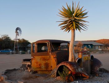 Abandoned car against clear sky