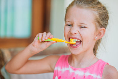 Close-up of cute girl brushing teeth