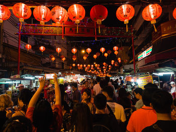 Crowd in illuminated city at night