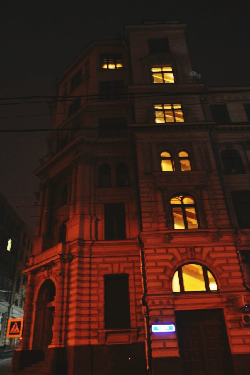 architecture, building exterior, low angle view, built structure, illuminated, night, window, building, street light, lighting equipment, sky, city, residential building, arch, outdoors, no people, residential structure, facade, exterior, brick wall